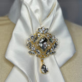 a crystal brooch pinned to an equestrian stock tie 