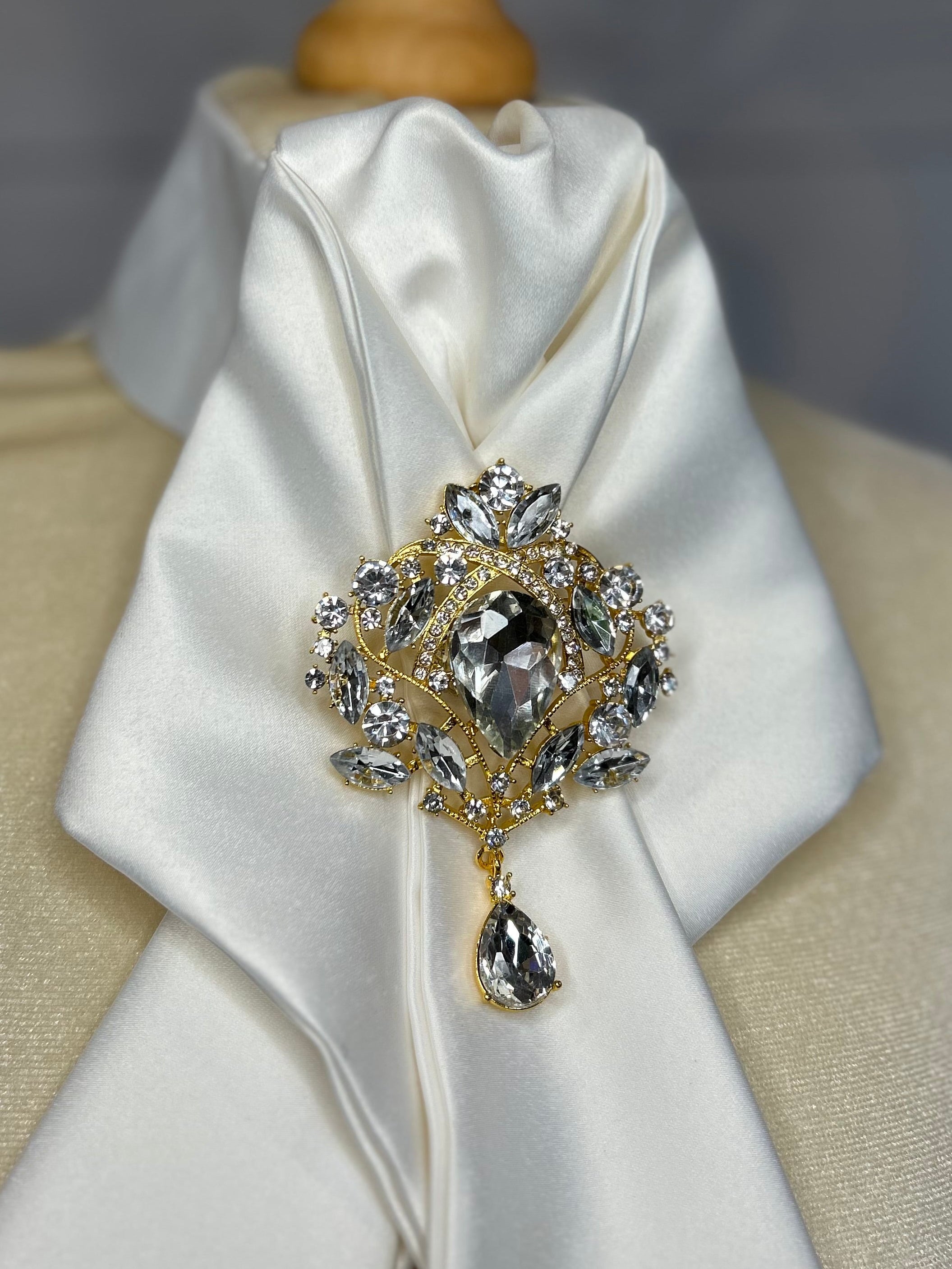 a crystal brooch pinned to an equestrian stock tie 