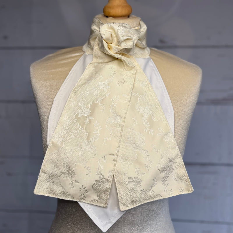 an equestrian cream patterned self tie stock tie on a mannequin 