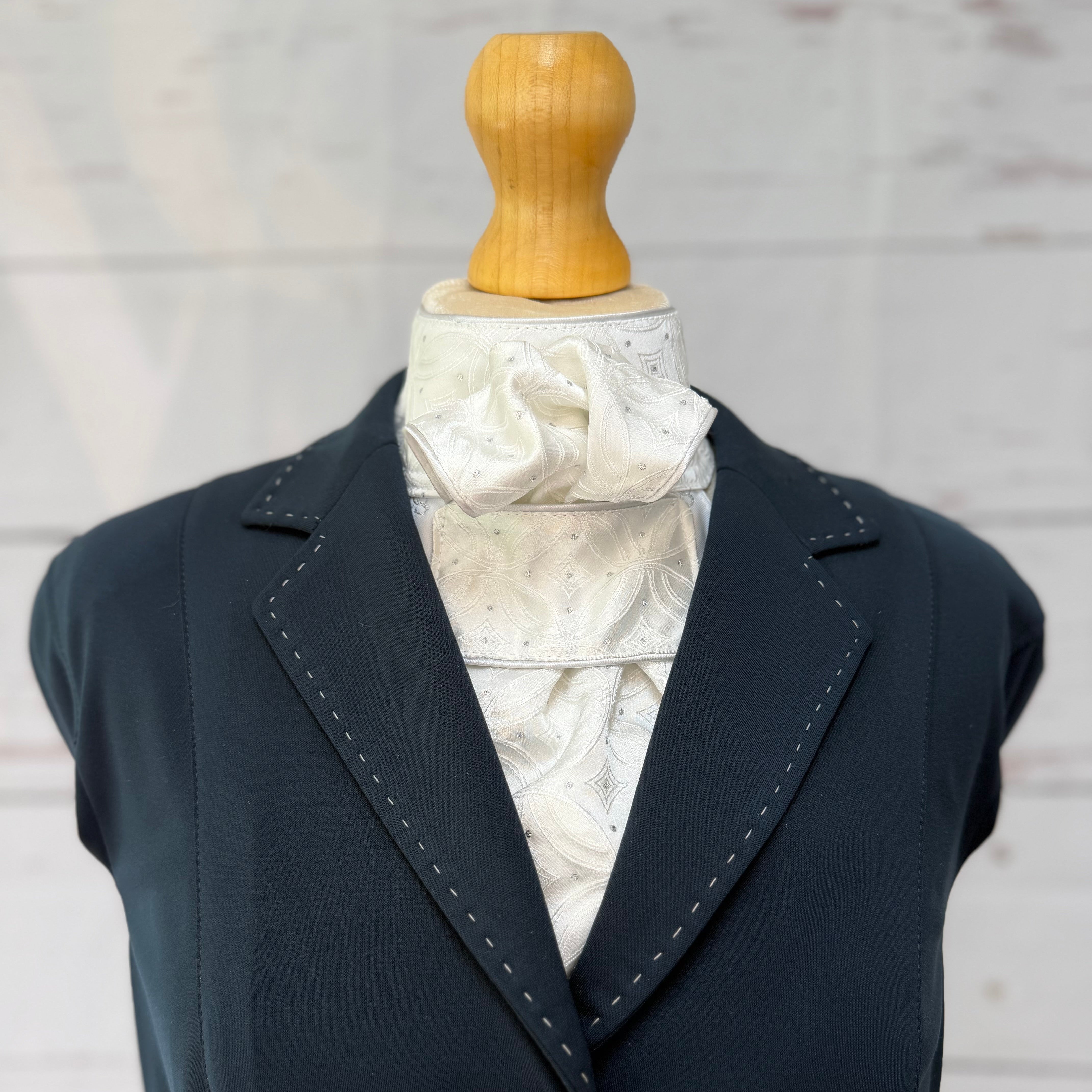 an equestrian ready tied stock tie on a mannequin in blue jacket 