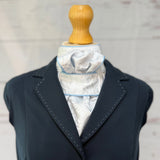 baby blue equestrian stock tie, with a blue jacket over the top. 