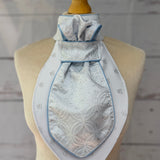 a baby blue equestrian stick tie with blue piping on a mannequin. 