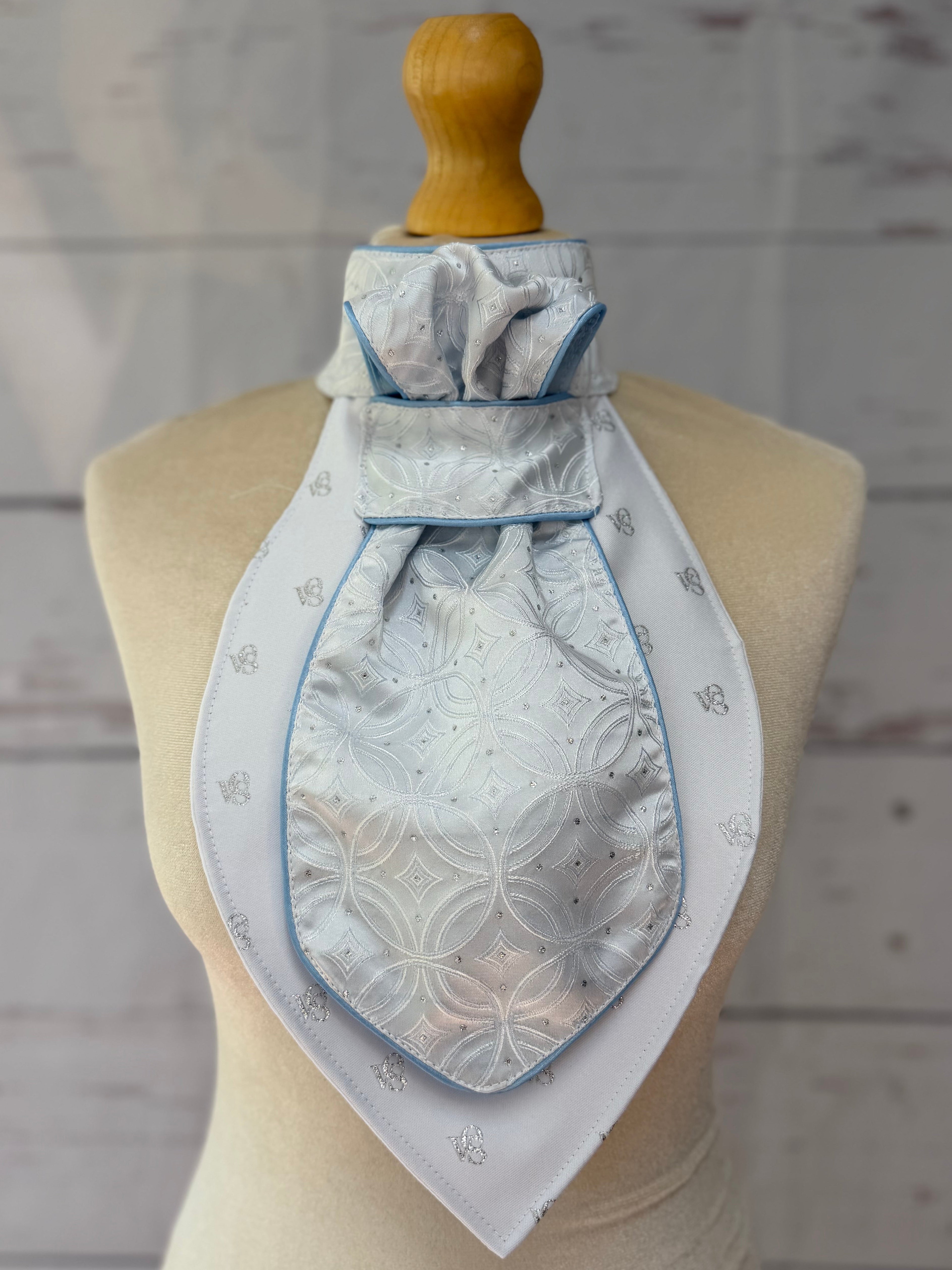a baby blue equestrian stick tie with blue piping on a mannequin. 
