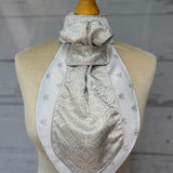 a silver equestrian stock tie on a mannequin
