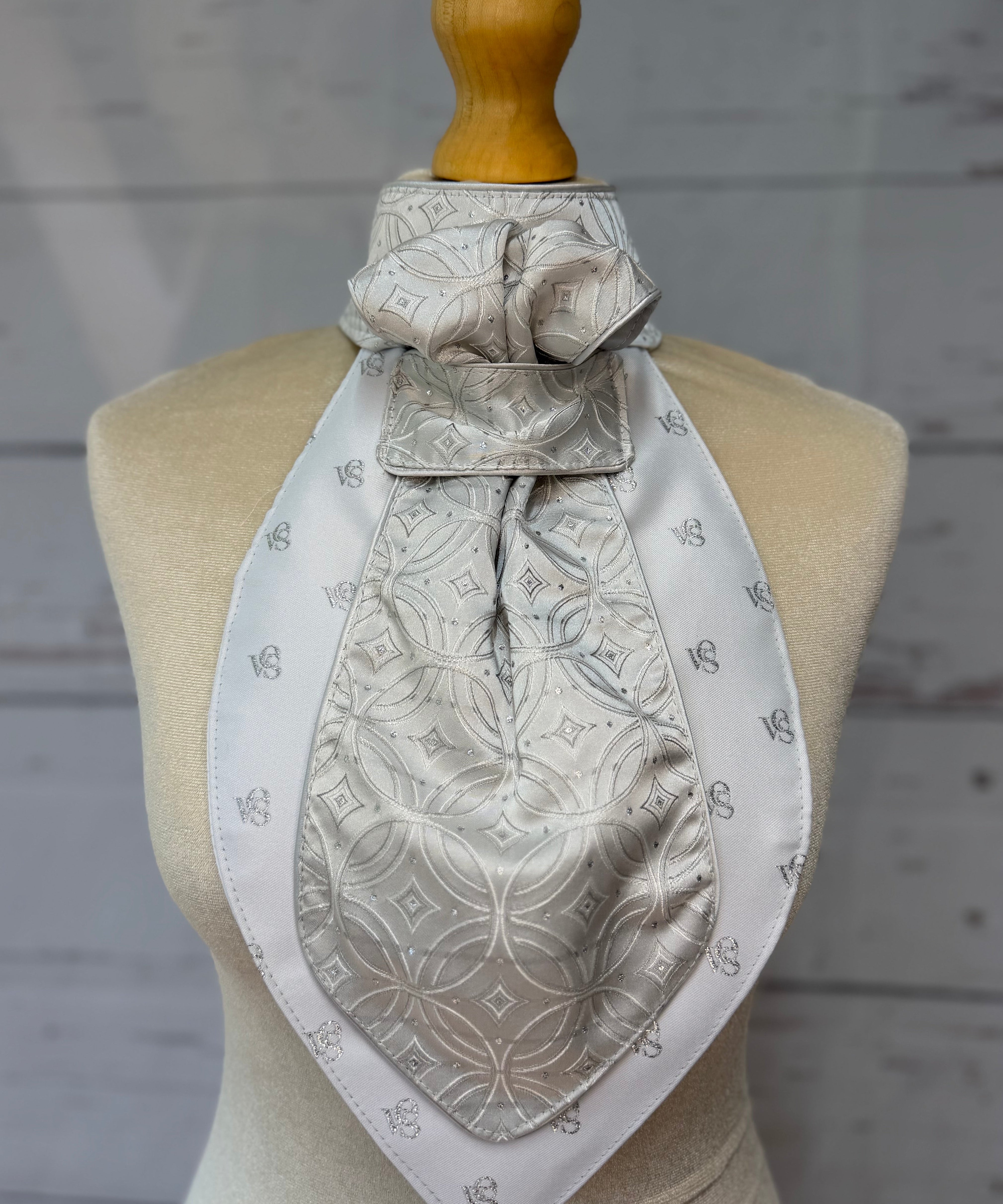a silver equestrian stock tie on a mannequin

