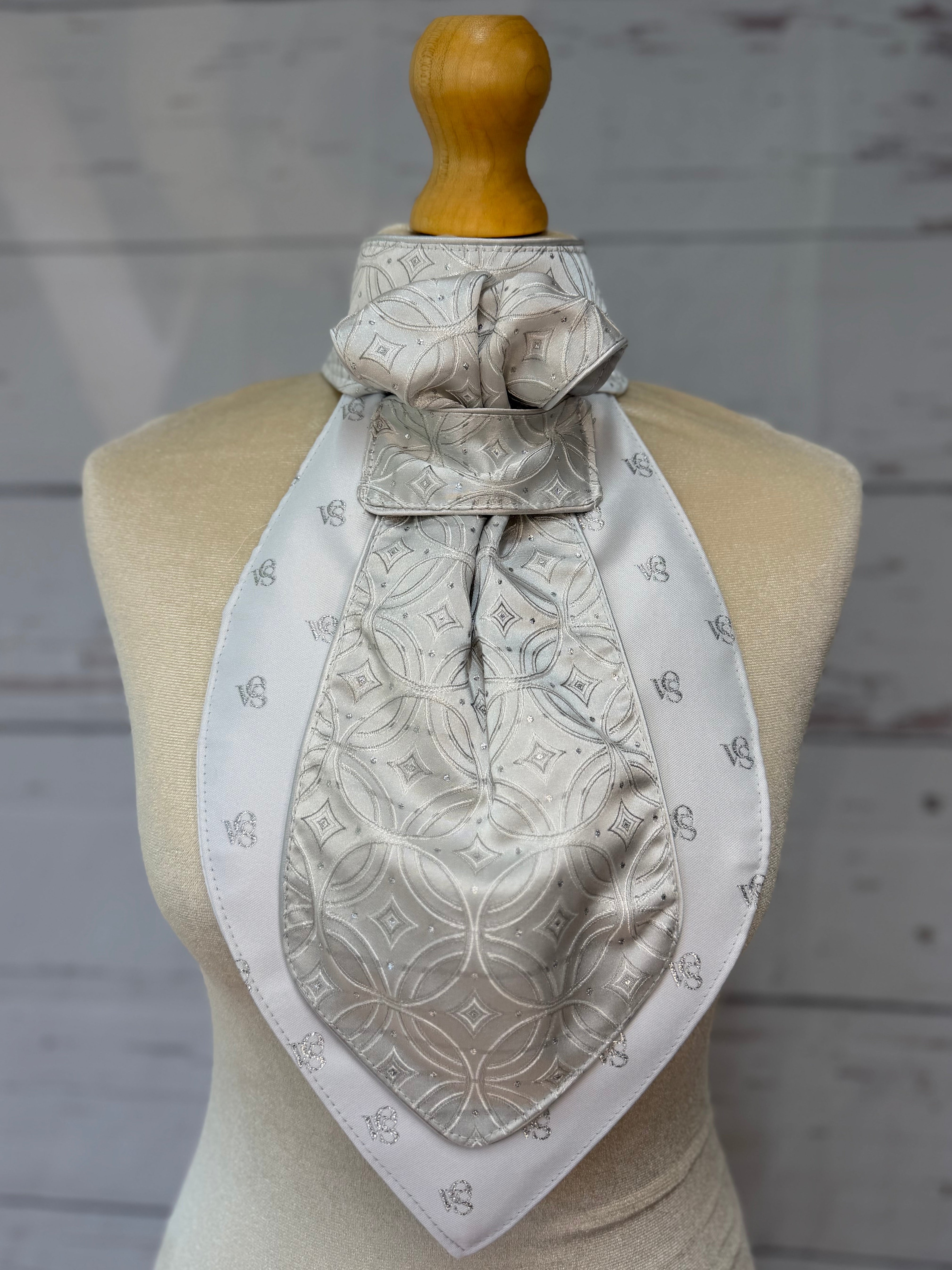 a silver equestrian stock tie on a mannequin
