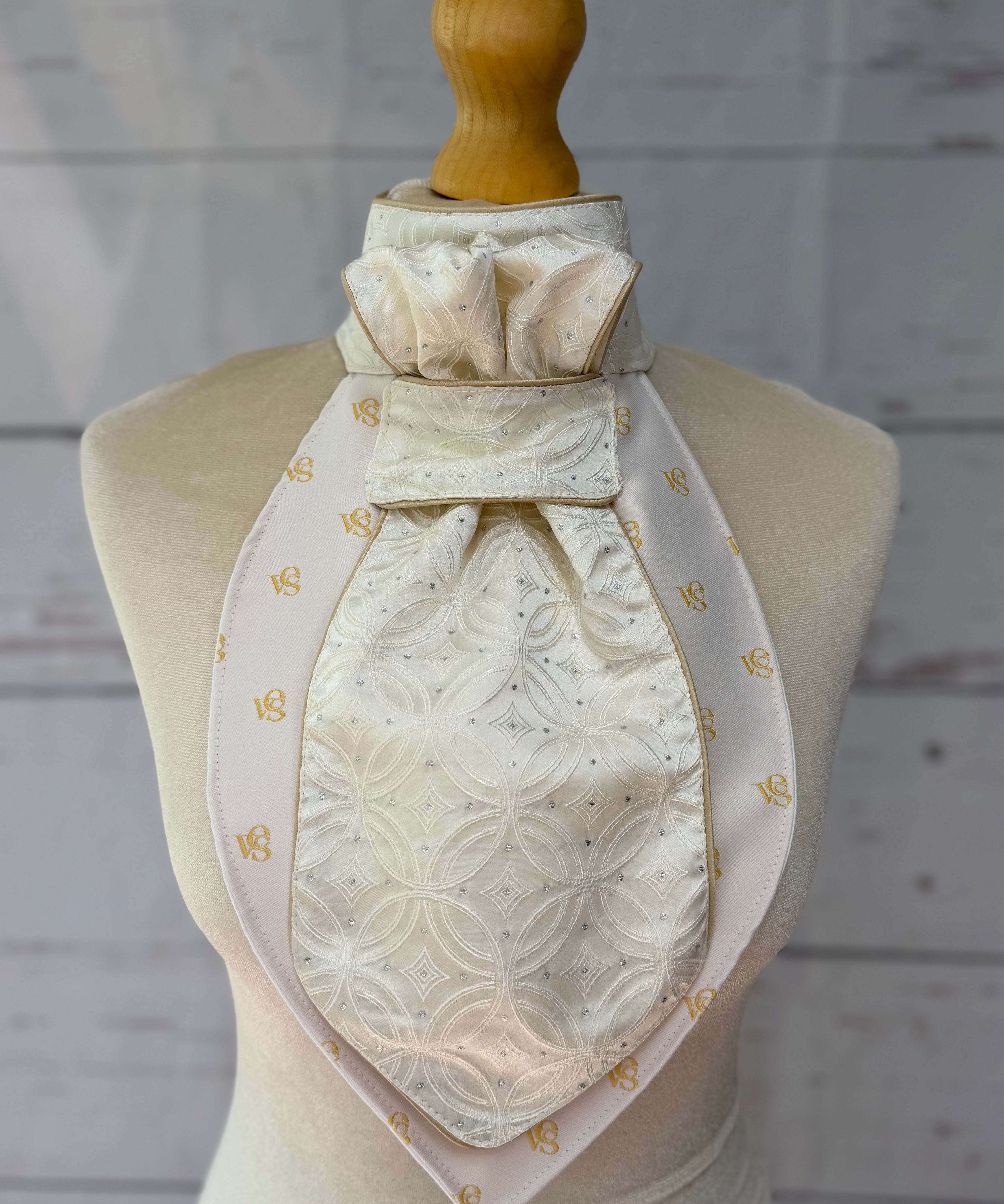 champagne equestrian stock tie with gold piping on a mannequin 
