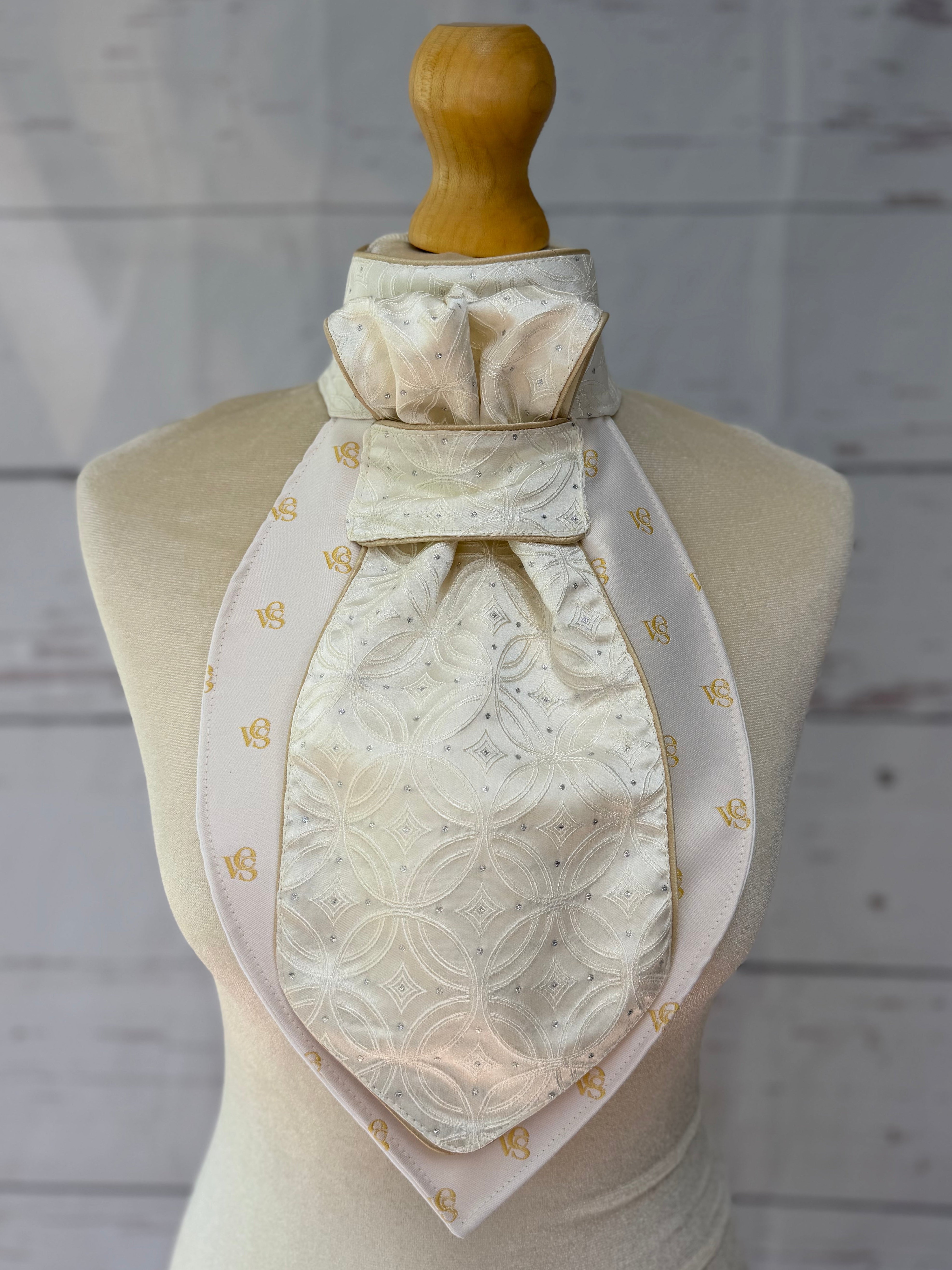 champagne equestrian stock tie with gold piping on a mannequin 