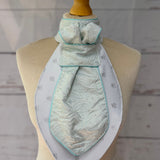 an aqua equestrian stock tie on a mannequin 