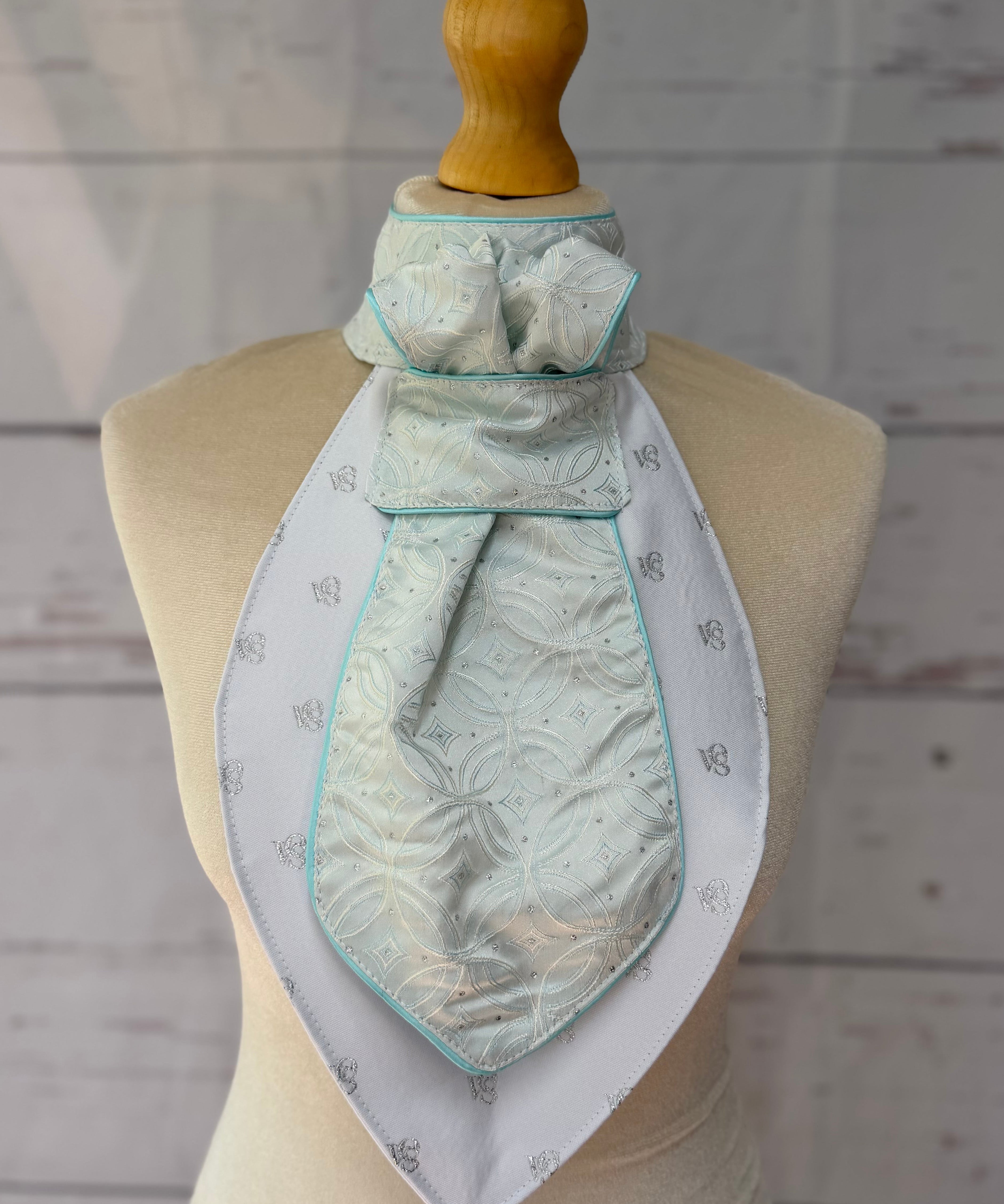 an aqua equestrian stock tie on a mannequin 