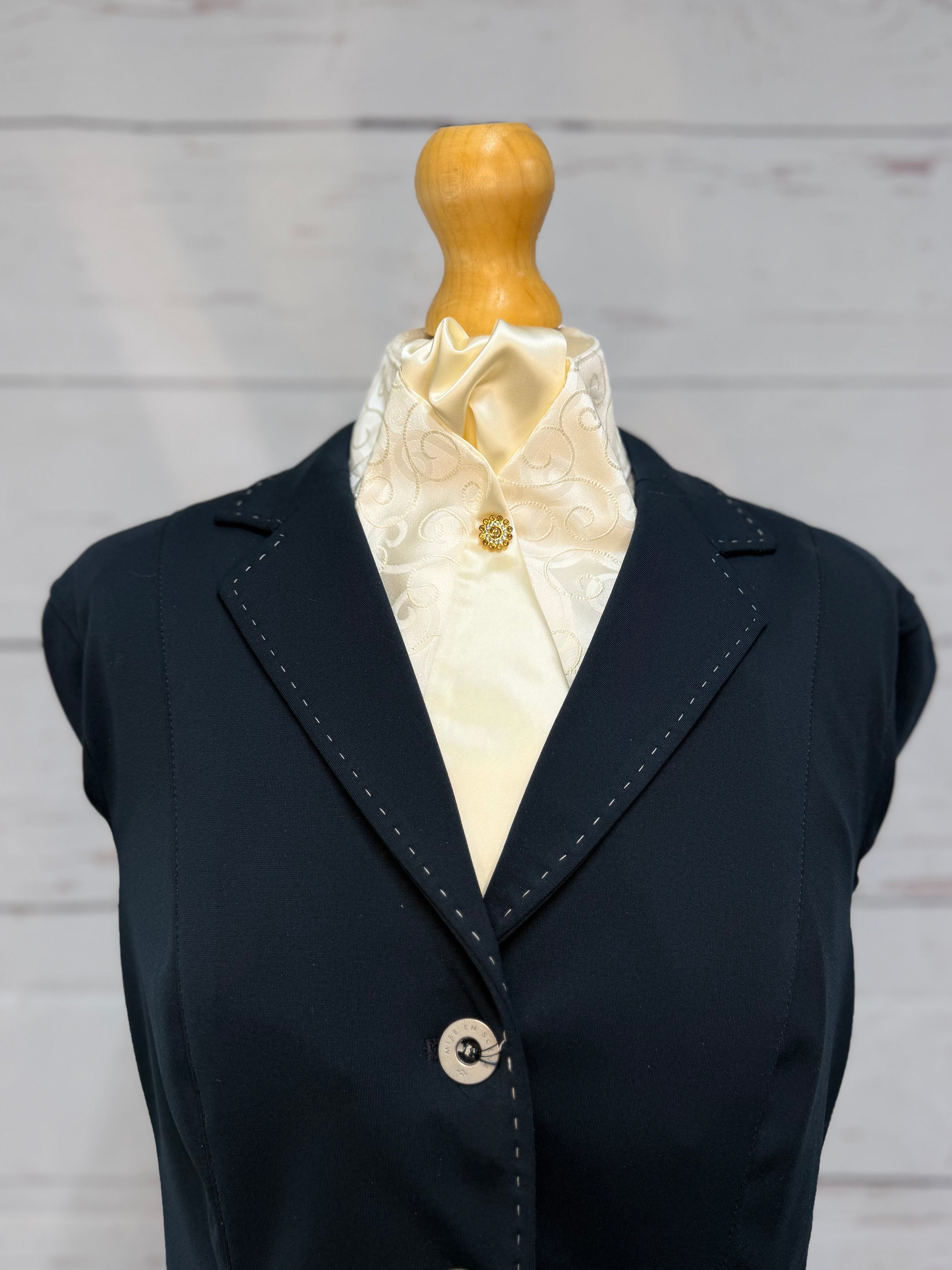a blue jacket with a cream stock tie on a mannequin