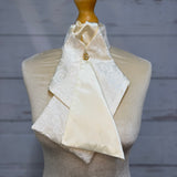 a cream stock tie on a mannequin
