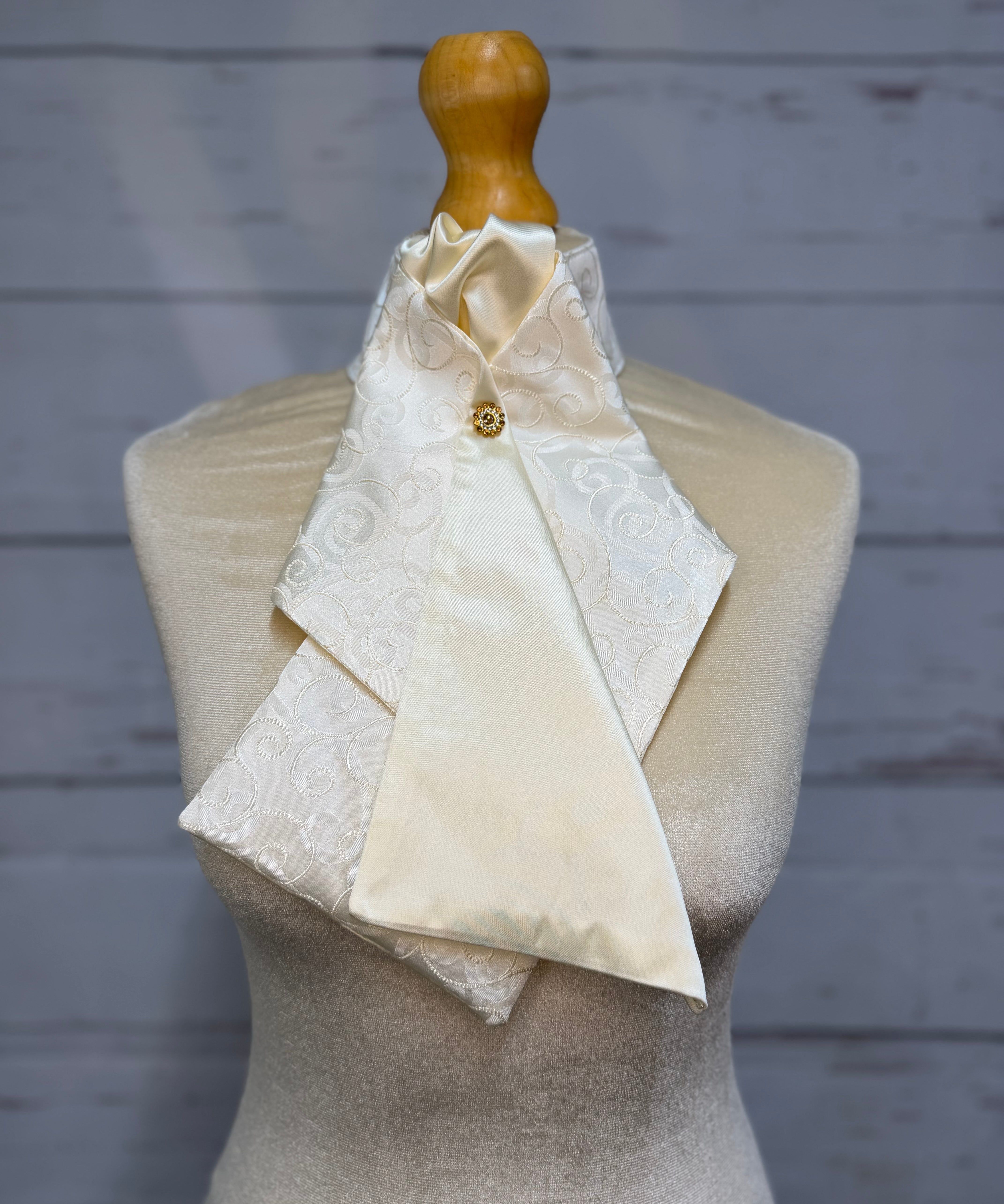 a cream stock tie on a mannequin
