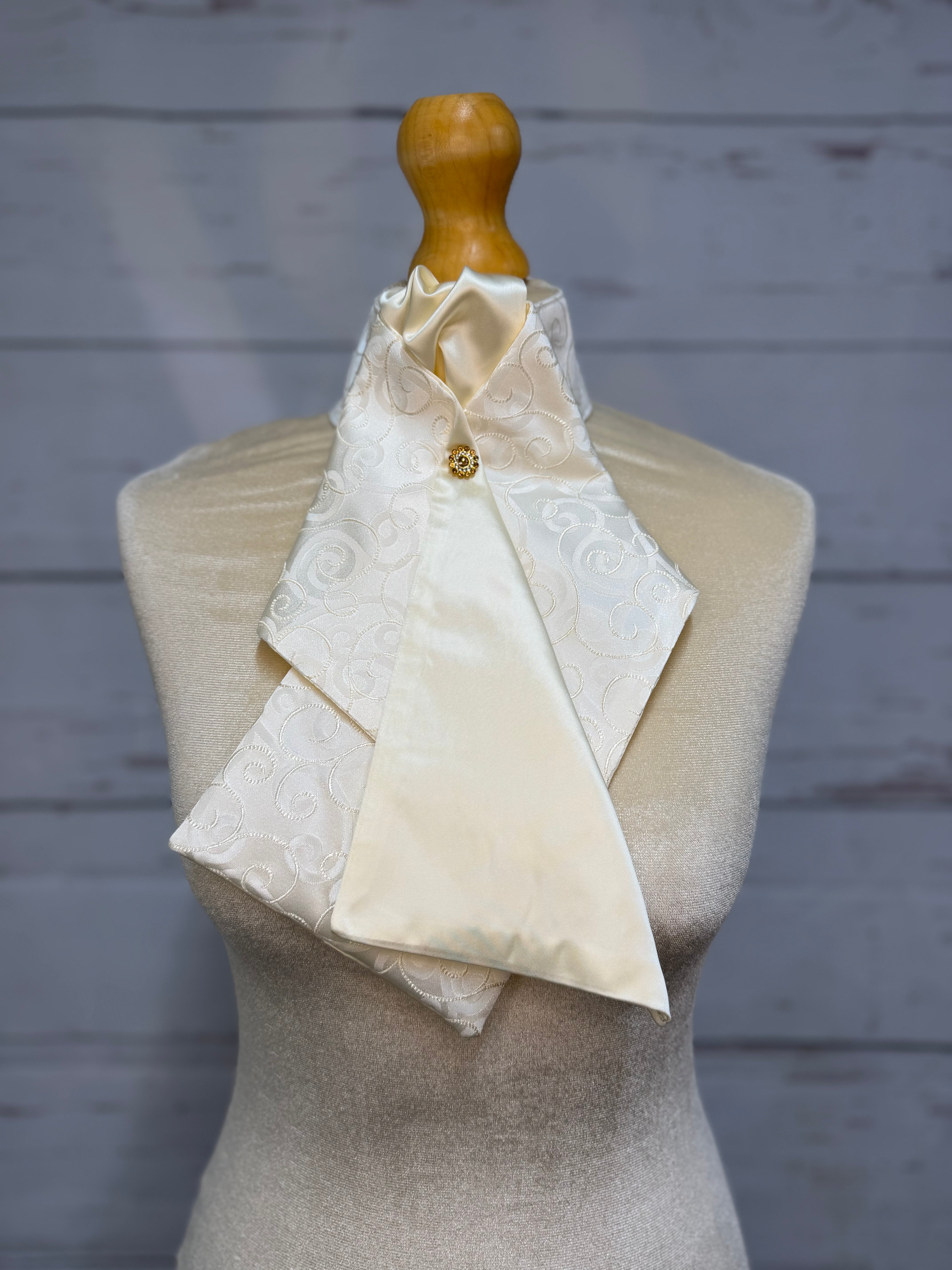 a cream stock tie on a mannequin
