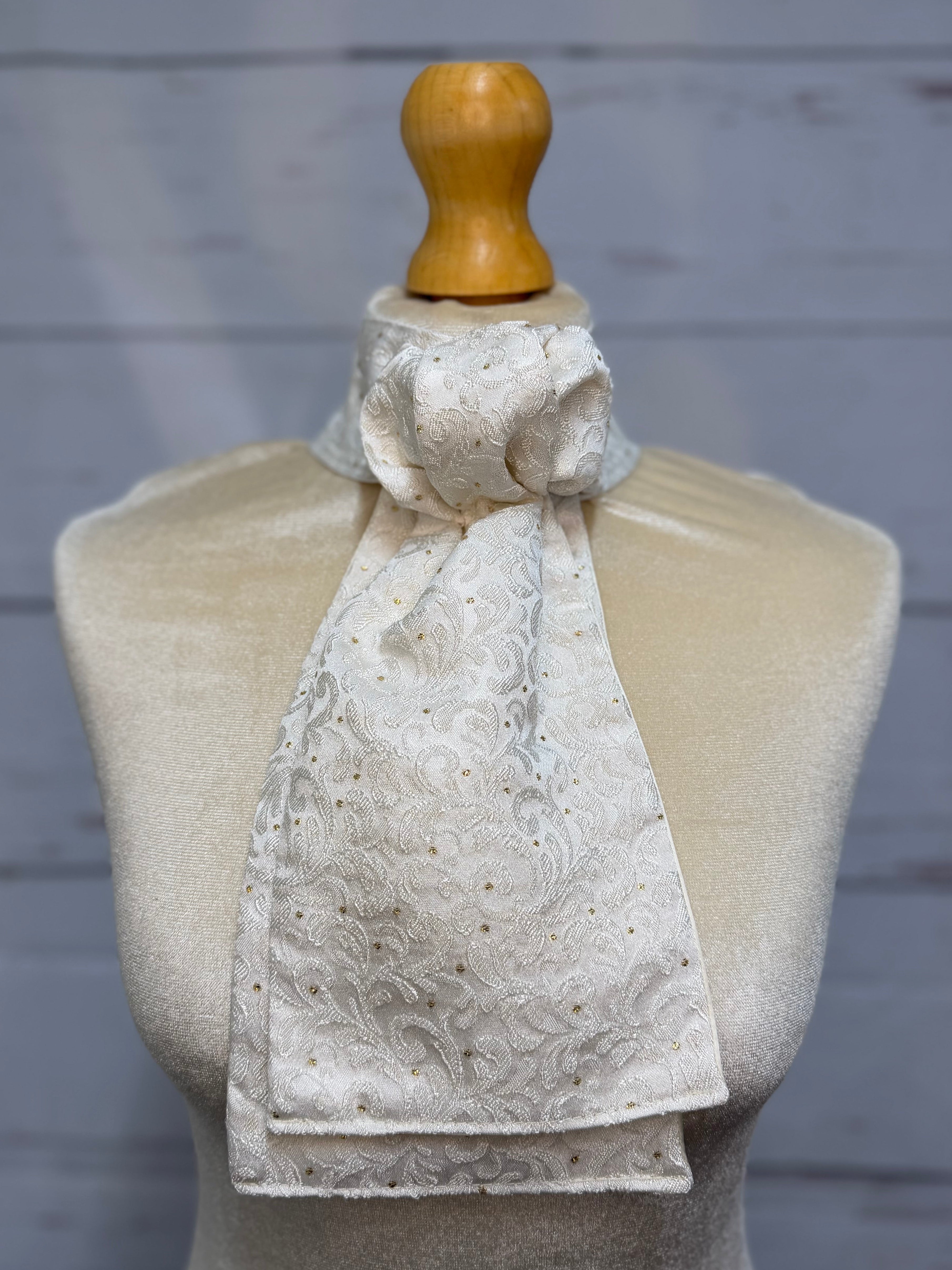 mannequin wearing gold and white stock tie 