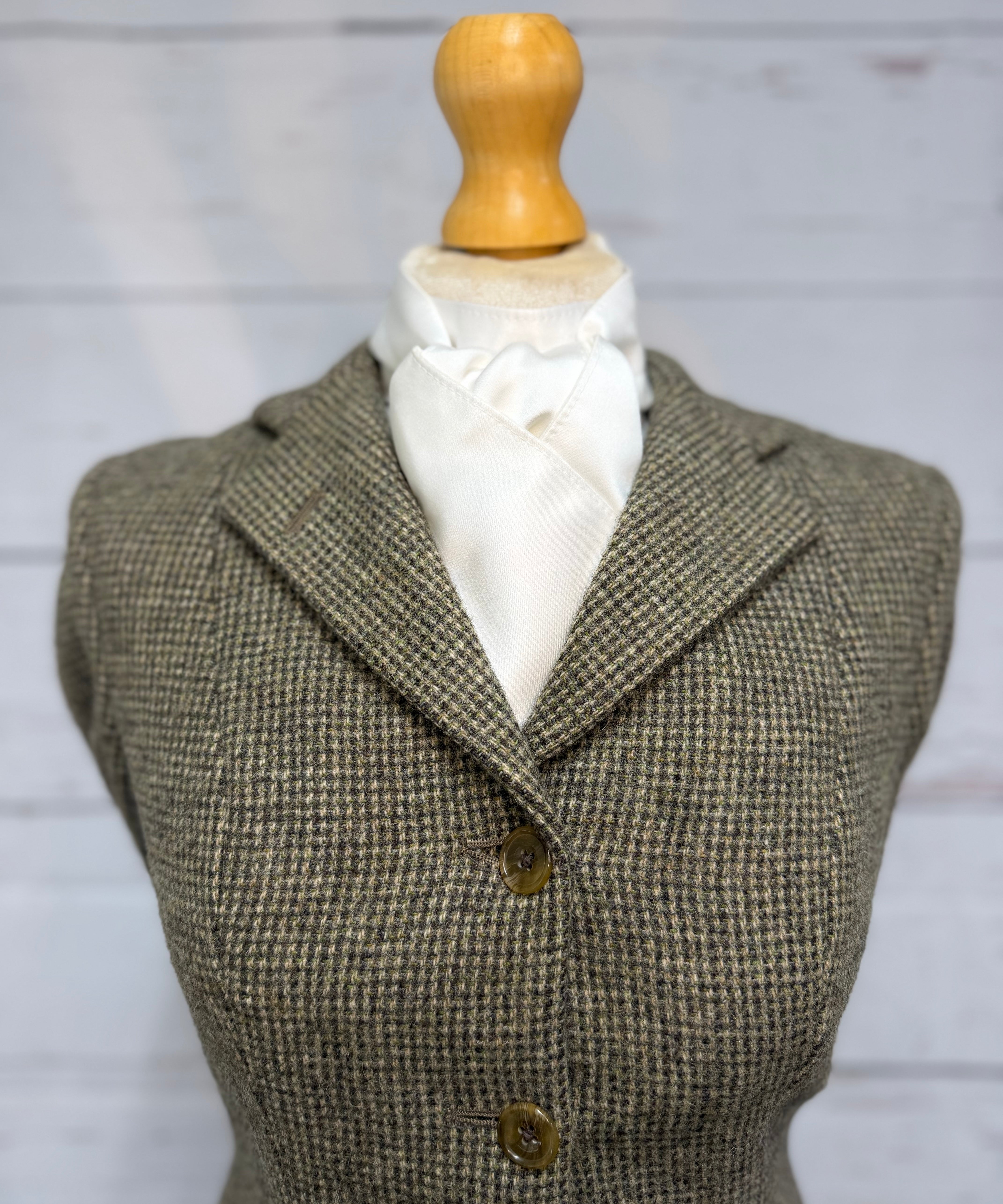 tweed jacket on a mannequin with a white satin stock tie
