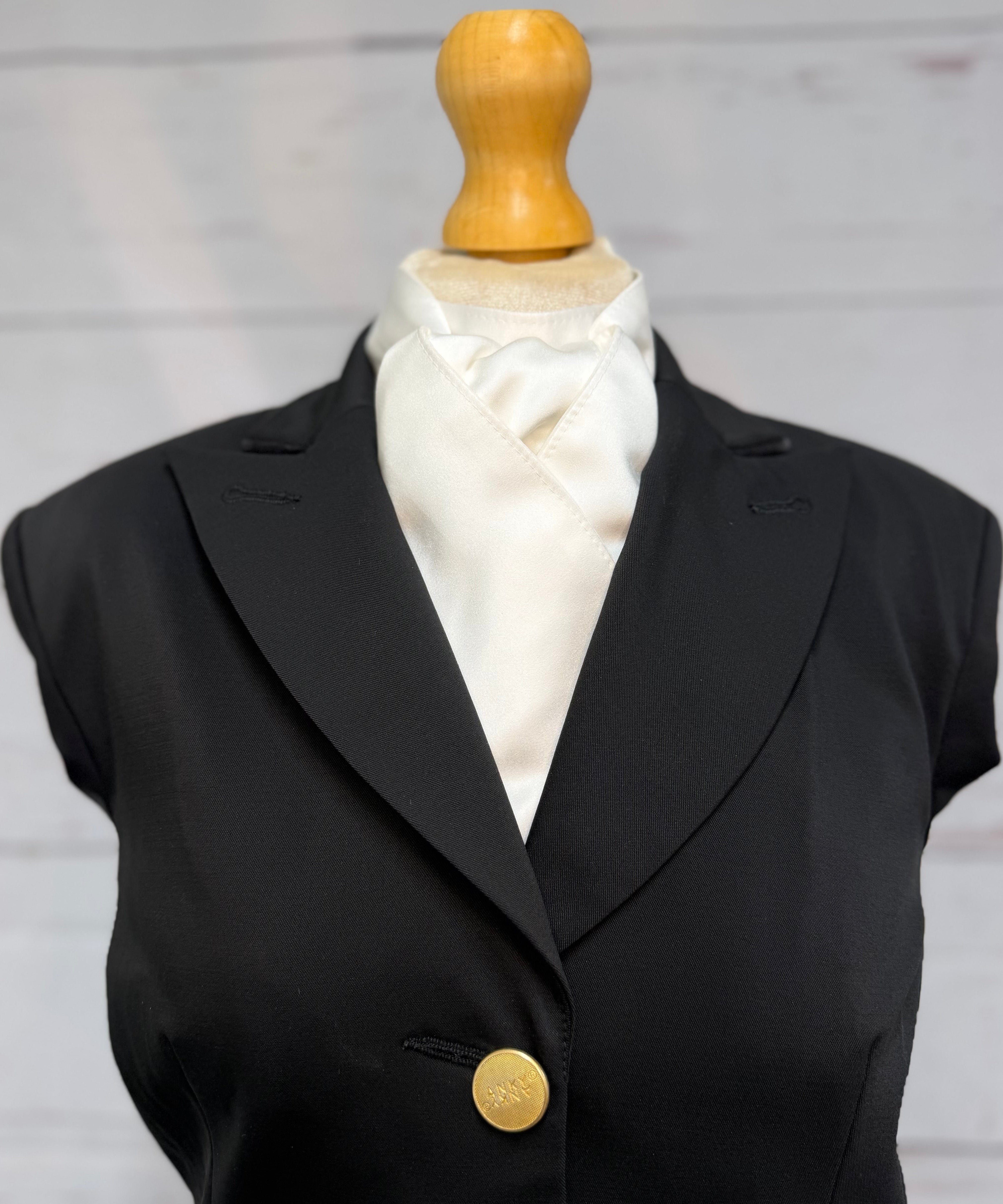 black jacket on mannequin with satin white stock tie 