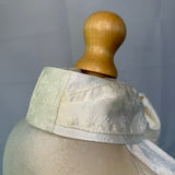 mannequin with satin stock tie, plain background