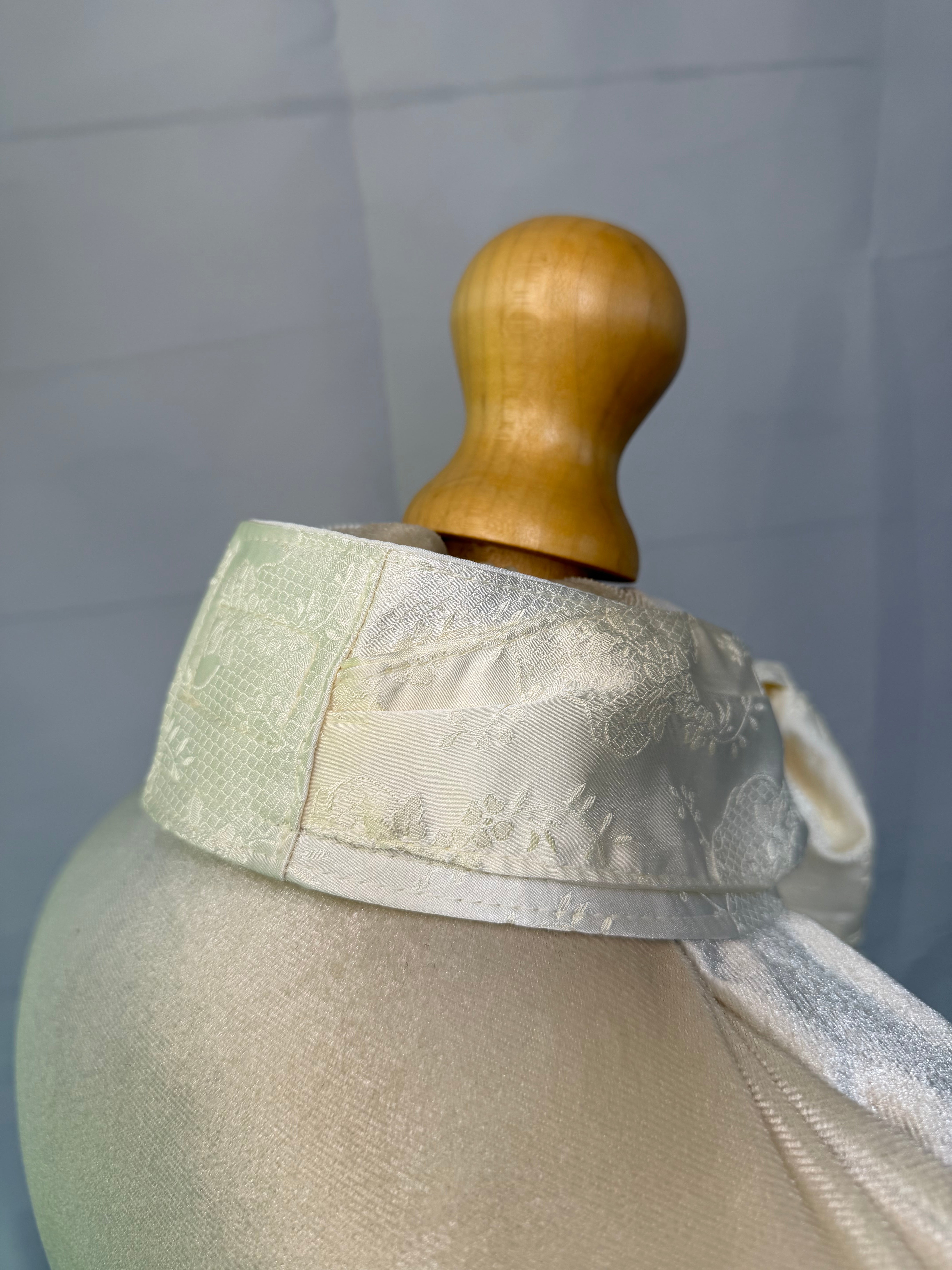 mannequin with satin stock tie, plain background